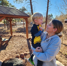Mother holding her child outdoors