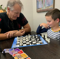 Dentist playing chess with a young patient