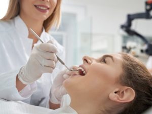 dentist checking patien's upper teeth