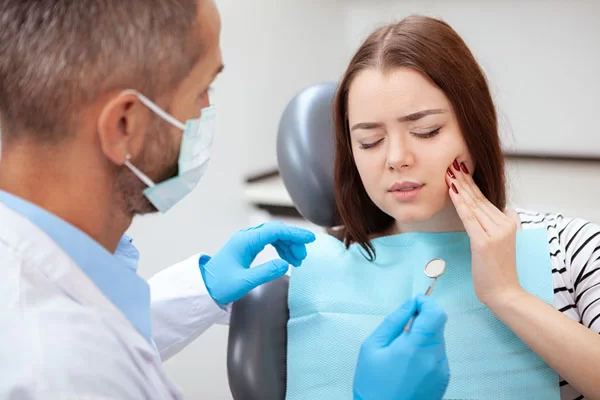 lady in pain at the dentist