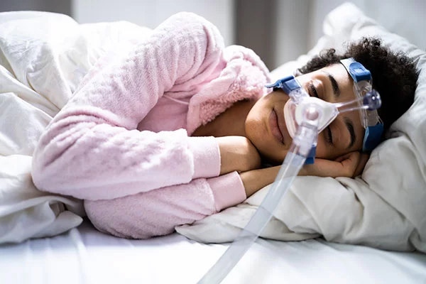 woman sleeping with a cpap/bipap mask