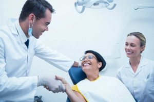 patient shaking hands with dentist