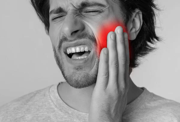 man experiencing dental pain