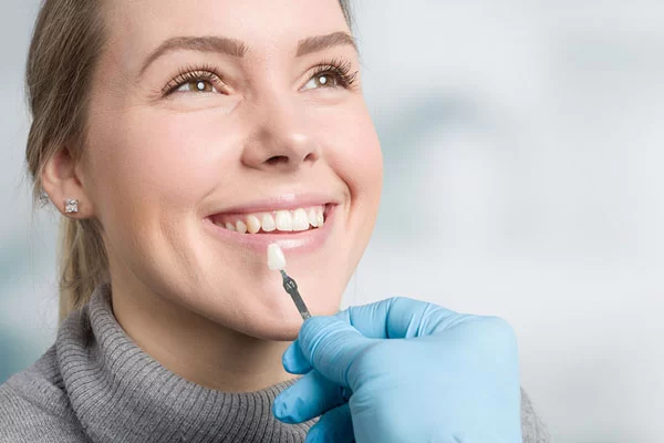 woman deciding the final shade for her porcelain veneers