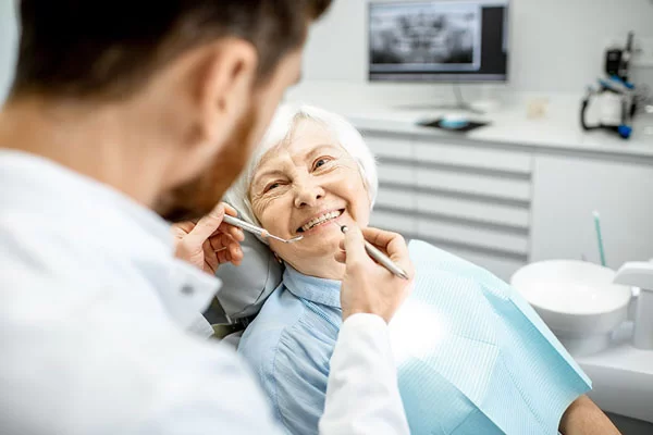 older woman on a denta chair preparing for dental checkup