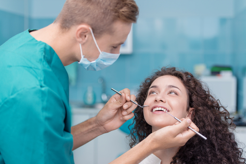 dental hygienist starting the dental cleaning process